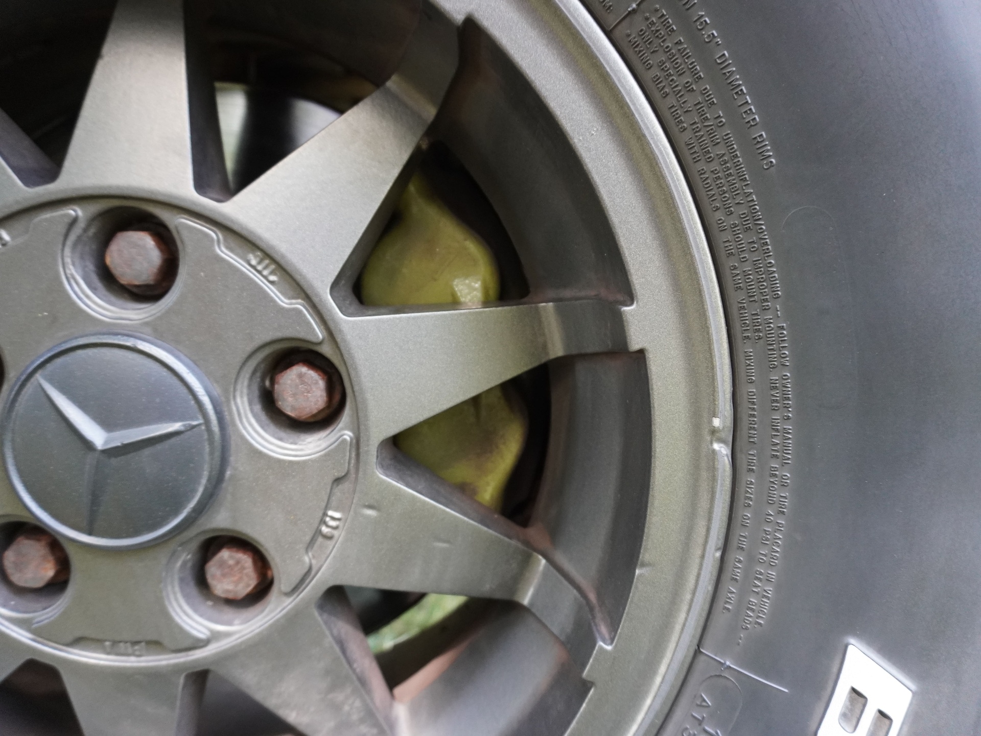 Yellow-painted brake caliper detail