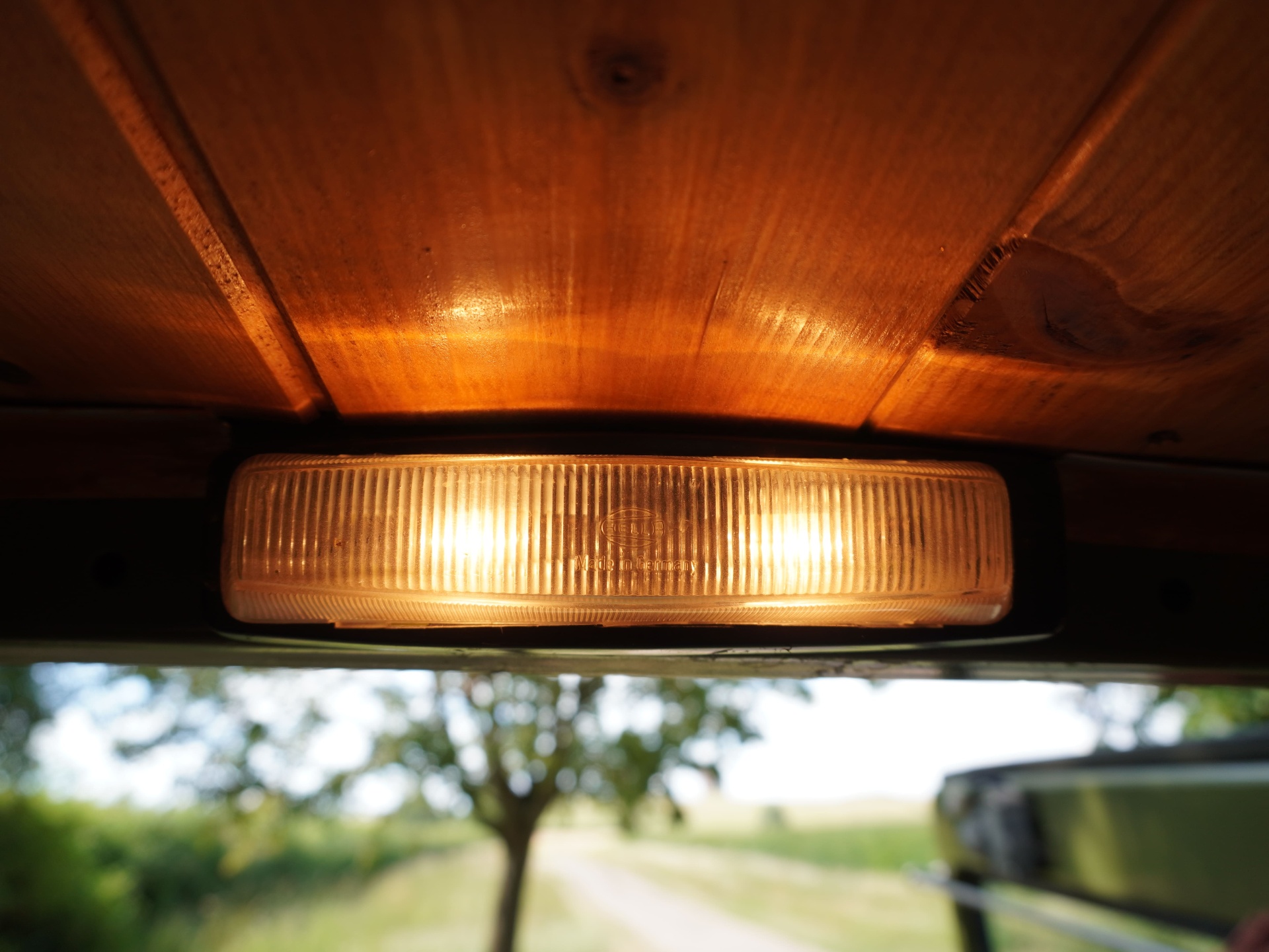 Hella cabin light under pine ceiling