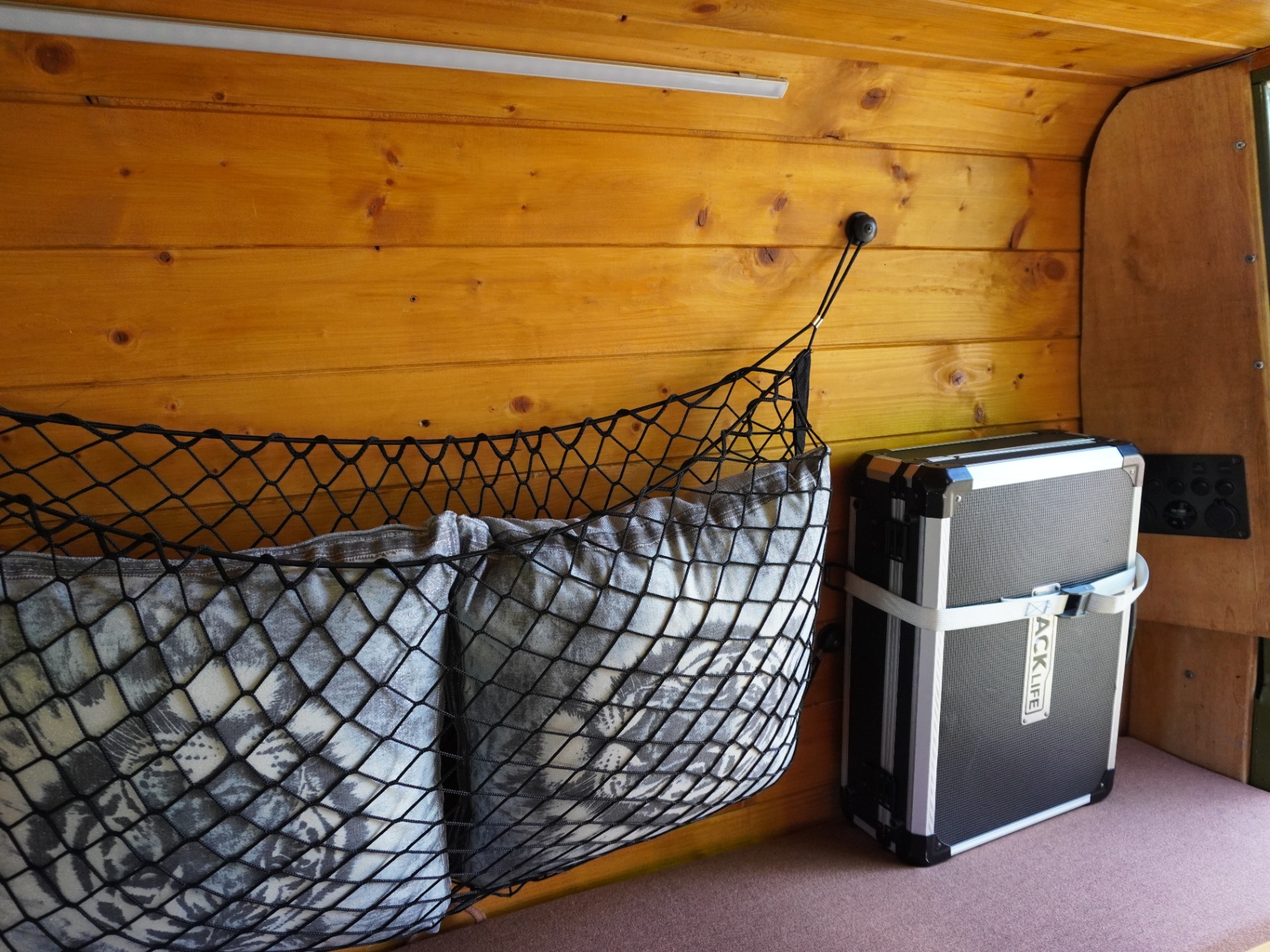 Wood cladding with storage net and equipment