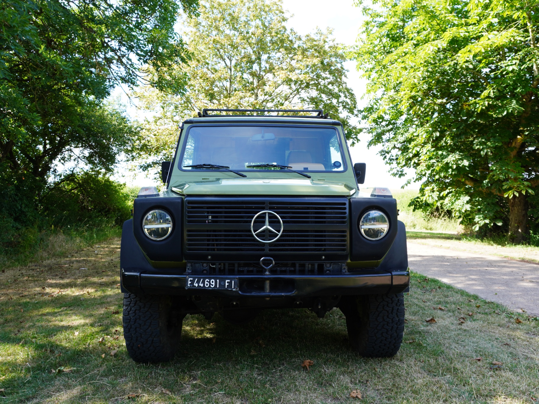 Front view of the olive green G-Wagon in the Italian countryside