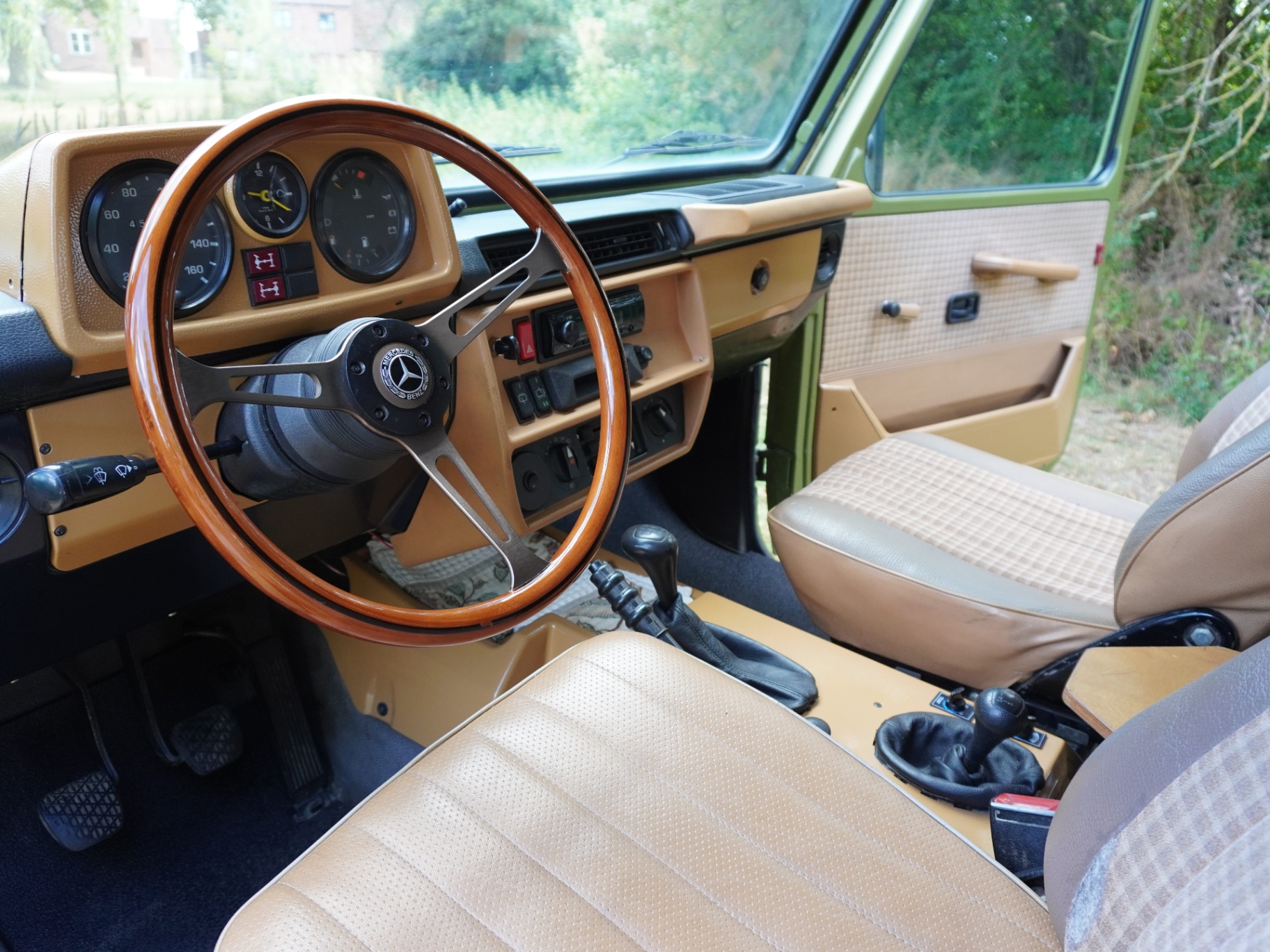 Tan cabin - wood-rim wheel, chequered cloth seats